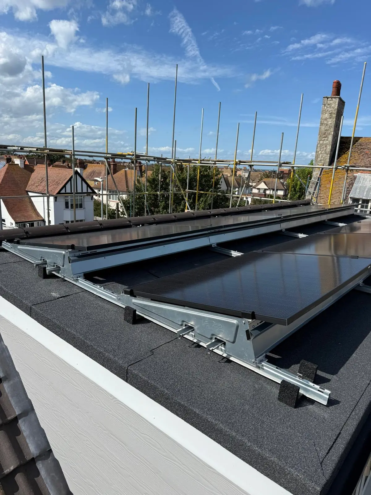 Galvanised A frame mounts set out across a felt flat roof before the panels were fitted.
